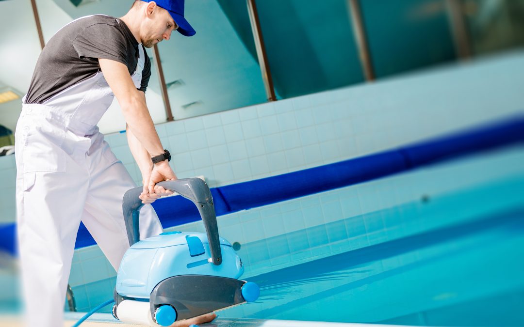 man using automated pool cleaner
